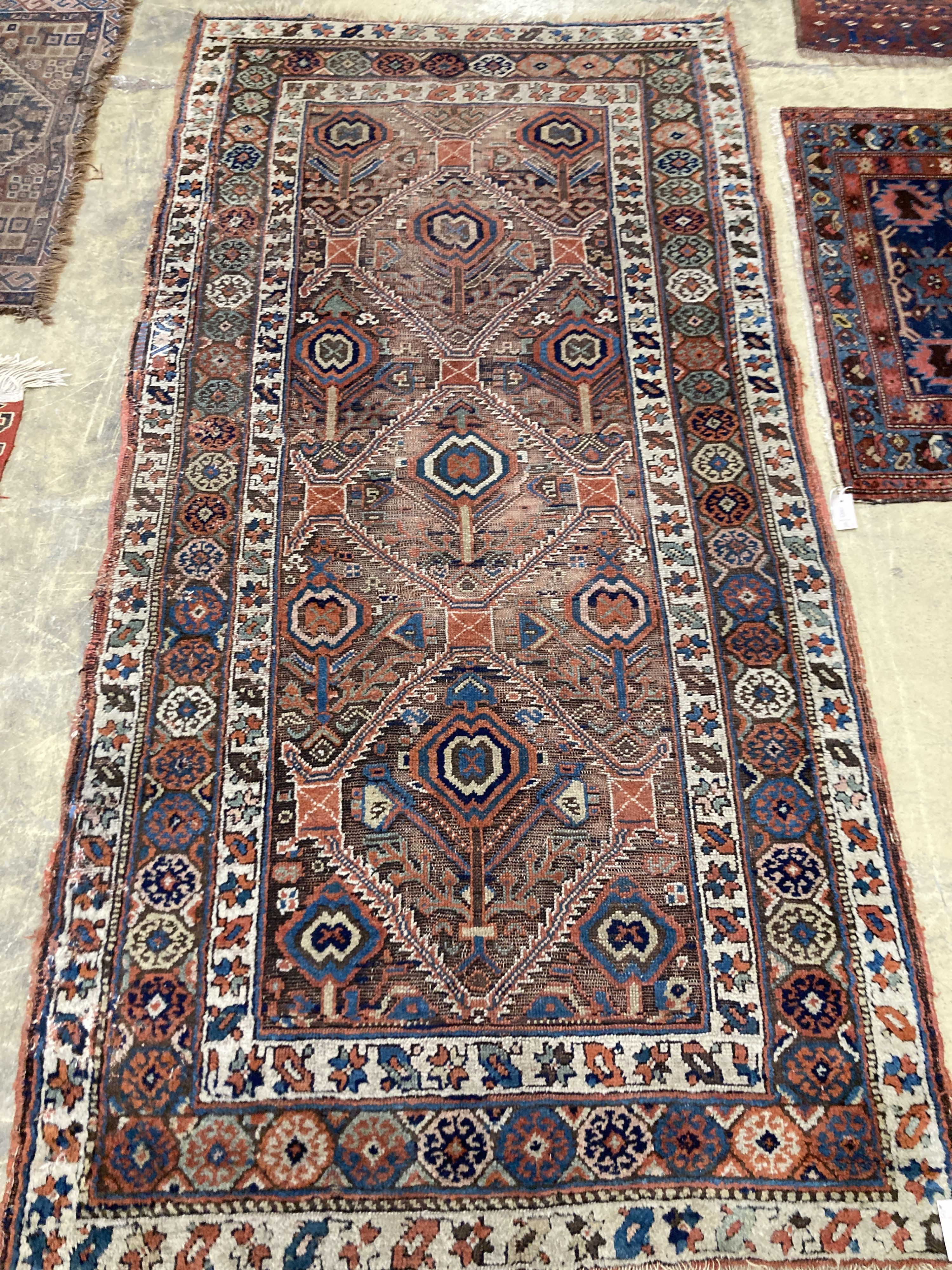 An antique Caucasian red ground rug, 250 x 125 cm and a smaller Shiraz rug.